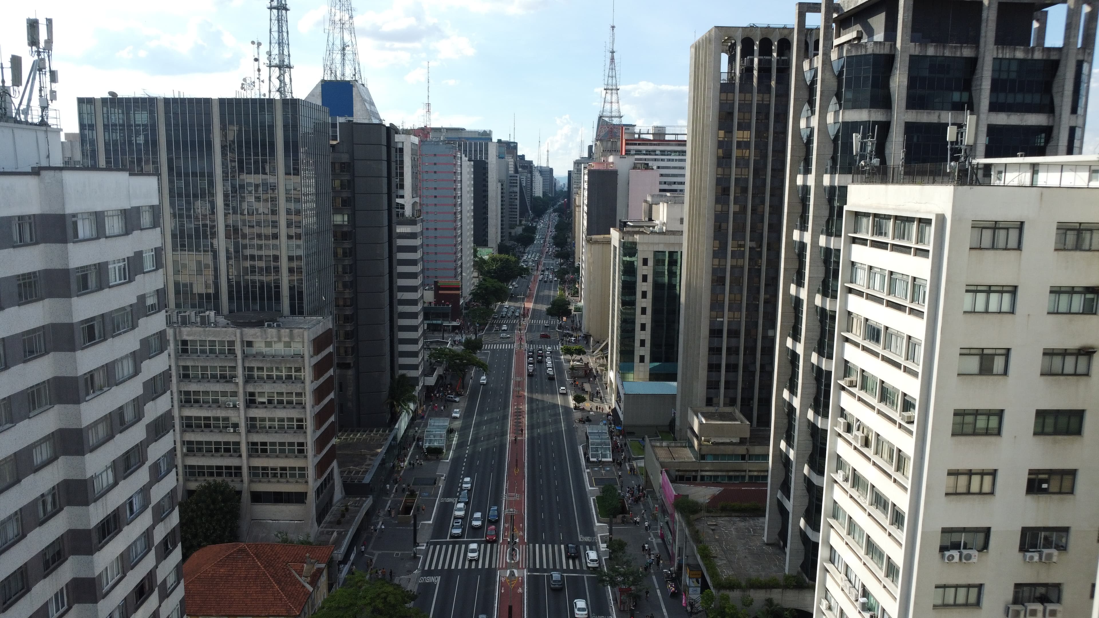 An aerial photograph of an avenue between buildings